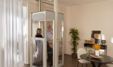 Three people on a modern Uplifts S3 home lift.